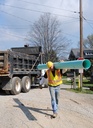 man carrying pipe 